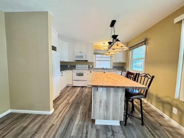 115 1st St SE, Pelican Rapids, MN 56572 - kitchen with white appliances, butcher block counters, dark wood-style flooring, and a sink