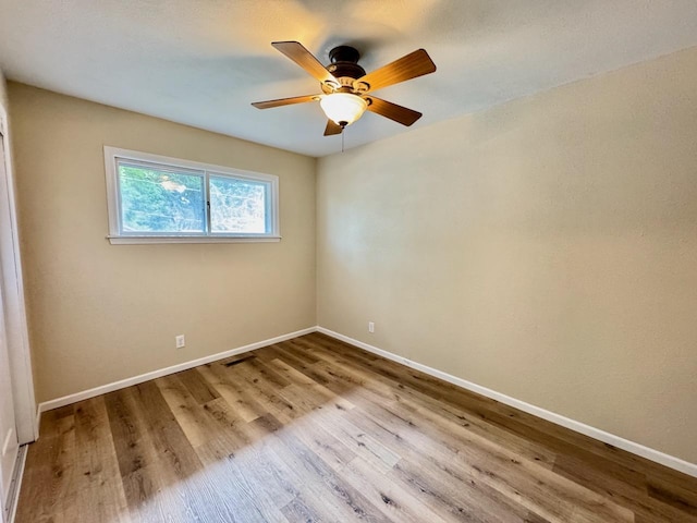 115 1st St SE, Pelican Rapids, MN 56572 - empty room with wood finished floors, baseboards, and a ceiling fan