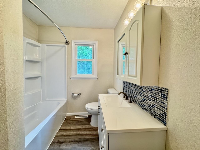 115 1st St SE, Pelican Rapids, MN 56572 - full bathroom featuring wood finished floors, toilet, vanity, baseboards, and shower / bath combination