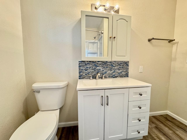 115 1st St SE, Pelican Rapids, MN 56572 - bathroom with toilet, wood finished floors, vanity, and baseboards