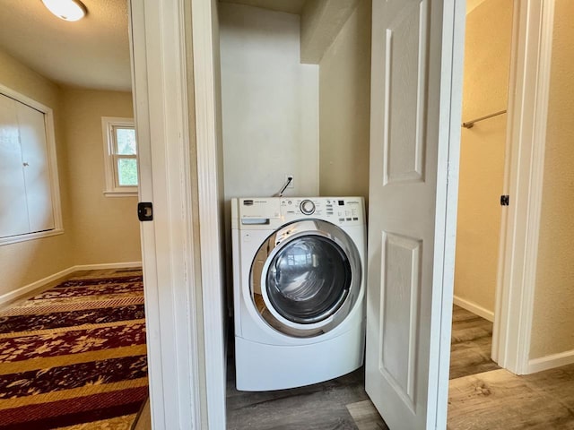 115 1st St SE, Pelican Rapids, MN 56572 - laundry area with washer / dryer, wood finished floors, and baseboards
