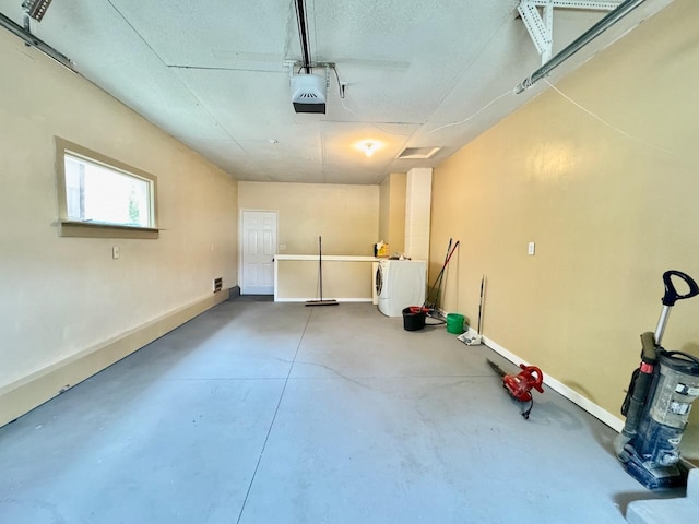 115 1st St SE, Pelican Rapids, MN 56572 - garage with a garage door opener, washer / clothes dryer, and baseboards