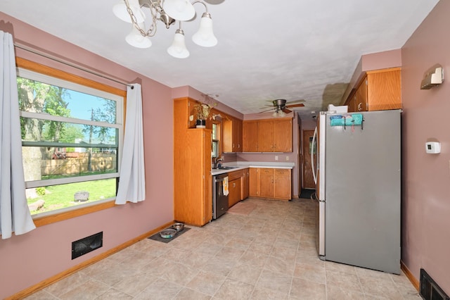 2003 20th Ave NW, Rochester, MN 55901 - kitchen featuring freestanding refrigerator, dishwasher, light countertops, baseboards, and a chandelier