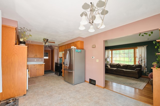 2003 20th Ave NW, Rochester, MN 55901 - kitchen with stainless steel refrigerator with ice dispenser, a chandelier, ceiling fan, light countertops, and white microwave