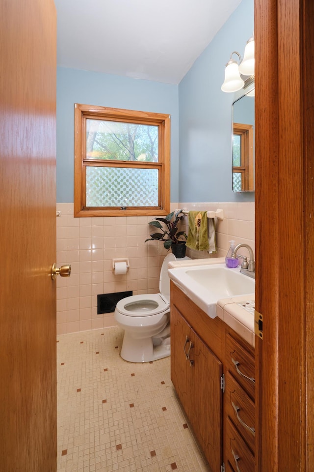 2003 20th Ave NW, Rochester, MN 55901 - bathroom with tile walls, vanity, healthy amount of natural light, toilet, and wainscoting