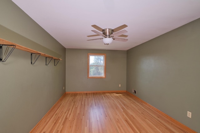 2003 20th Ave NW, Rochester, MN 55901 - spare room with light wood finished floors, a ceiling fan, and baseboards