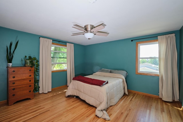 2003 20th Ave NW, Rochester, MN 55901 - bedroom featuring wood finished floors, baseboards, and a ceiling fan