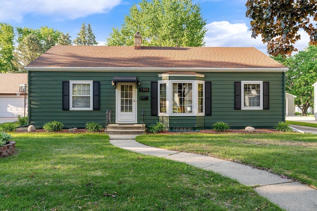1306 3rd Ave SW, Austin, MN 55912 - view of front of property featuring a chimney, a front yard, and a shingled roof
