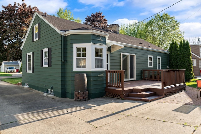 1306 3rd Ave SW, Austin, MN 55912 - view of front facade featuring a chimney, a deck, and roof with shingles