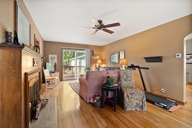 1306 3rd Ave SW, Austin, MN 55912 - living area featuring light wood finished floors, a fireplace, and a ceiling fan