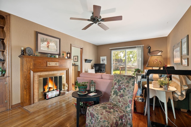 1306 3rd Ave SW, Austin, MN 55912 - living area featuring a glass covered fireplace, wood finished floors, a ceiling fan, and a textured wall