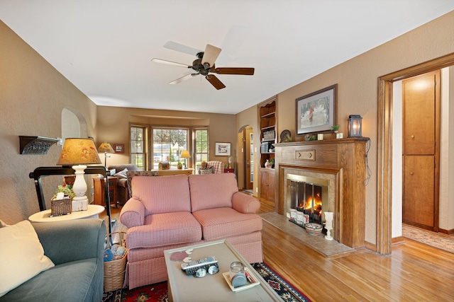 1306 3rd Ave SW, Austin, MN 55912 - living room with a ceiling fan, a warm lit fireplace, and wood finished floors