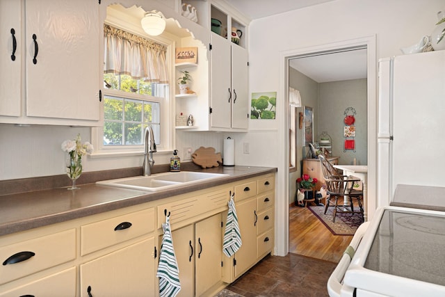 1306 3rd Ave SW, Austin, MN 55912 - kitchen with a sink, open shelves, freestanding refrigerator, range, and dark countertops