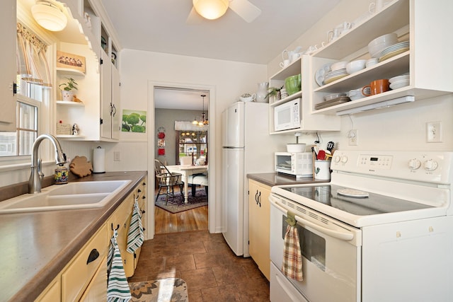 1306 3rd Ave SW, Austin, MN 55912 - kitchen with white appliances, open shelves, a sink, dark countertops, and a chandelier