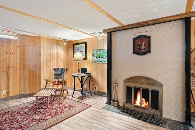 1306 3rd Ave SW, Austin, MN 55912 - sitting room with wood finished floors, wooden walls, a fireplace, and baseboards