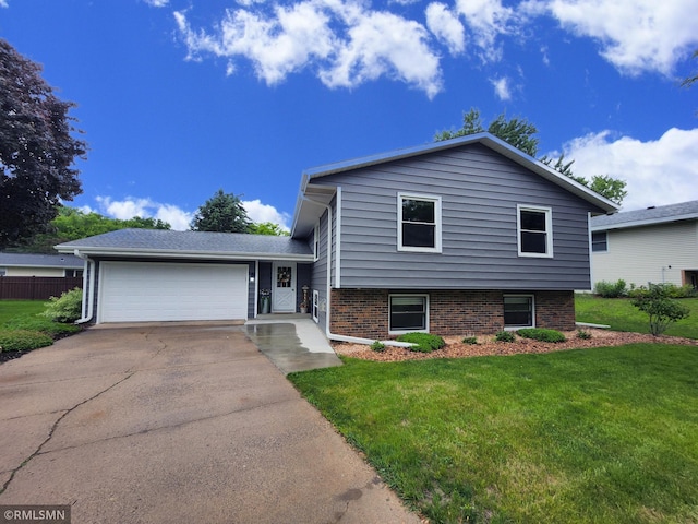 1879 Carol Ln, West Saint Paul, MN 55118 - tri-level home with a garage, driveway, and brick siding