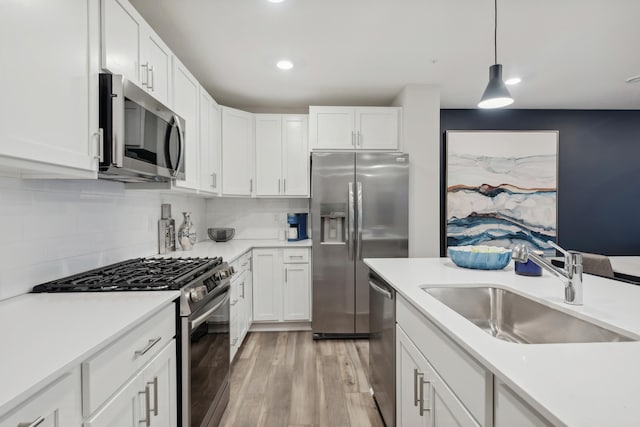 14970 Archdale Ln, Rosemount, MN 55068 - kitchen featuring stainless steel appliances, a sink, white cabinetry, light countertops, and recessed lighting
