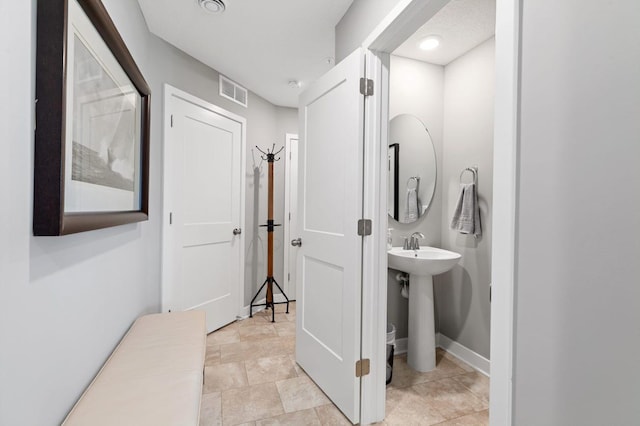 14970 Archdale Ln, Rosemount, MN 55068 - bathroom featuring a sink, baseboards, and stone finish flooring