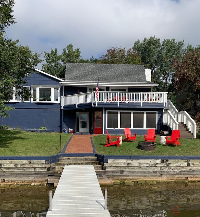 6412 Conroy St NE, Prior Lake, MN 55372 - rear view of house featuring stairs, an outdoor fire pit, a lawn, a shingled roof, and a deck with water view