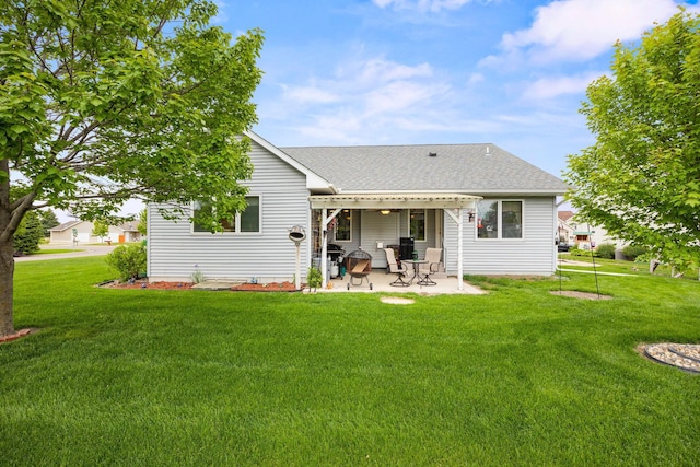 2101 Blake Ave, Lester Prairie, MN 55354 - rear view of house featuring a patio area, a lawn, and a shingled roof