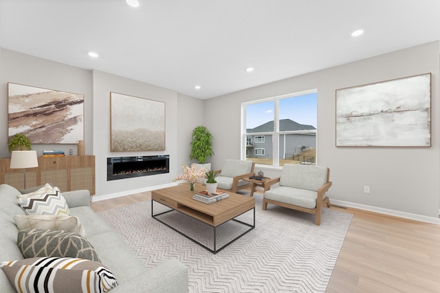 10664 29th St NE, Saint Michael, MN 55376 - living room featuring light wood finished floors, recessed lighting, a glass covered fireplace, and baseboards