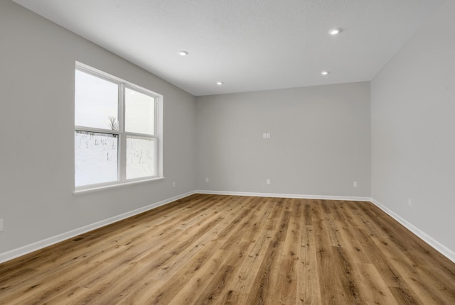 10664 29th St NE, Saint Michael, MN 55376 - spare room featuring wood finished floors, baseboards, and recessed lighting