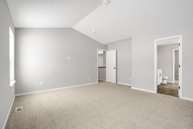 10664 29th St NE, Saint Michael, MN 55376 - unfurnished bedroom with carpet floors, lofted ceiling, baseboards, and ensuite bath