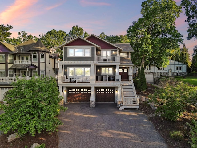 17209 Grays Bay Blvd, Minnetonka, MN 55391 - view of front of home with a balcony, driveway, stairs, and a garage