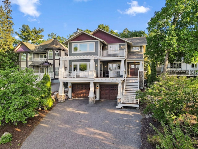 17209 Grays Bay Blvd, Minnetonka, MN 55391 - view of front of house featuring stairs, driveway, a garage, and stone siding