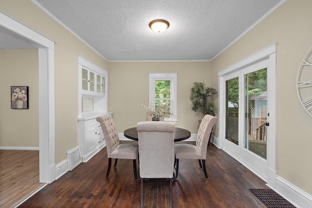 248 Ivy Ave W, Saint Paul, MN 55117 - dining area featuring ornamental molding, a textured ceiling, dark wood-style flooring, and baseboards