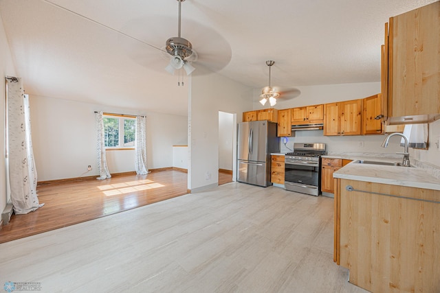 838 8th Ave E, West Fargo, ND 58078 - kitchen featuring appliances with stainless steel finishes, a sink, a ceiling fan, vaulted ceiling, and under cabinet range hood