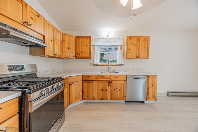 838 8th Ave E, West Fargo, ND 58078 - kitchen with appliances with stainless steel finishes, a sink, under cabinet range hood, a baseboard heating unit, and light countertops