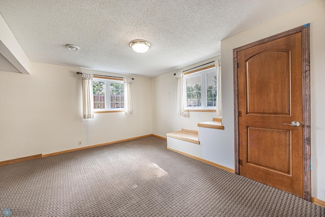 838 8th Ave E, West Fargo, ND 58078 - unfurnished bedroom featuring carpet floors, baseboards, and a textured ceiling