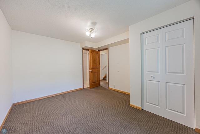838 8th Ave E, West Fargo, ND 58078 - unfurnished bedroom featuring carpet, baseboards, a closet, and a textured ceiling