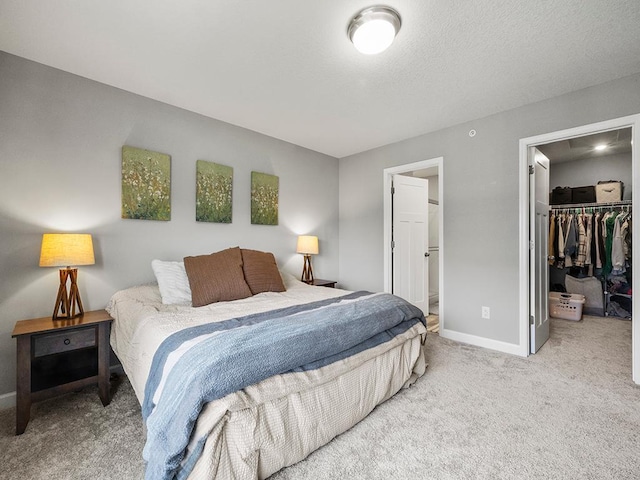 14540 112th Ave N, Dayton, MN 55369 - bedroom with carpet, a spacious closet, baseboards, a closet, and connected bathroom