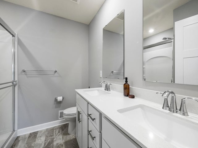 14540 112th Ave N, Dayton, MN 55369 - full bath featuring baseboards, toilet, double vanity, an enclosed shower, and marble look tiles