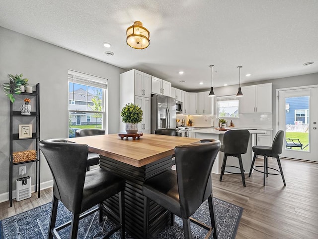 14540 112th Ave N, Dayton, MN 55369 - dining space with light wood finished floors, recessed lighting, baseboards, and a textured ceiling