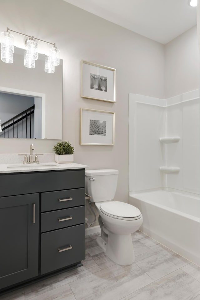 906 Woodlawn Ave Unit D, Saint Paul, MN 55116 - bathroom featuring toilet, vanity, bathing tub / shower combination, and baseboards