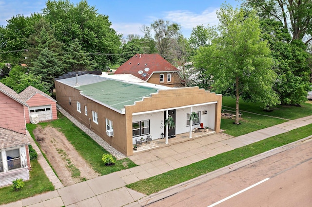 460 Broadway St E, New Germany, MN 55367 - view of front of home with stucco siding, a front yard, a patio, driveway, and an outdoor structure