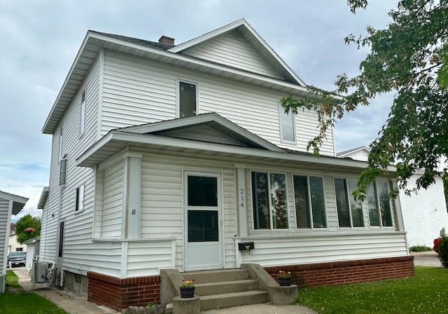 214 2nd St SW, Wadena, MN 56482 - view of front of house with entry steps, a chimney, and central AC unit