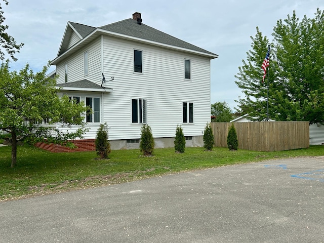 214 2nd St SW, Wadena, MN 56482 - view of home's exterior featuring a shingled roof and a chimney