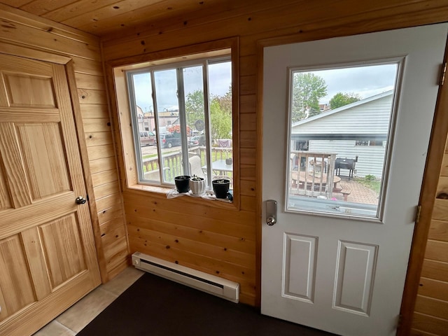 214 2nd St SW, Wadena, MN 56482 - doorway with a baseboard heating unit, wooden walls, and light tile patterned floors