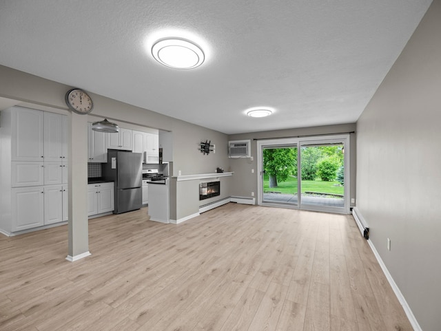 10720 Rockford Rd Unit 113, Plymouth, MN 55442 - unfurnished living room with light wood-style flooring, baseboards, a baseboard radiator, a glass covered fireplace, and a wall unit AC