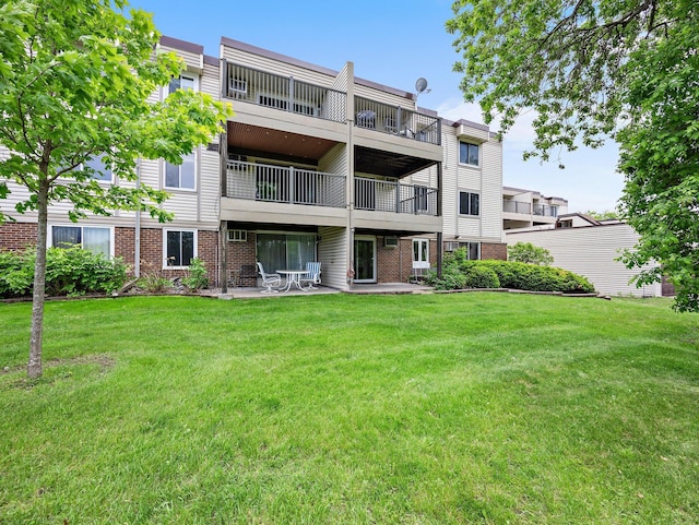 10720 Rockford Rd Unit 113, Plymouth, MN 55442 - rear view of house with a balcony, brick siding, a yard, and a patio area