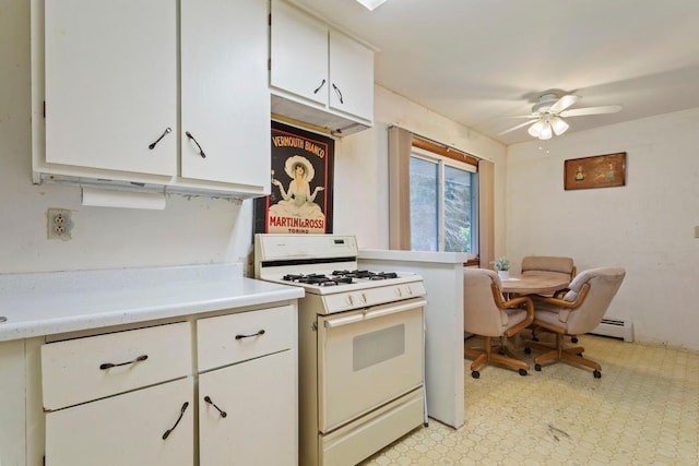 8309 39th St N, Lake Elmo, MN 55042 - kitchen featuring gas range gas stove, a baseboard heating unit, light countertops, ceiling fan, and light floors