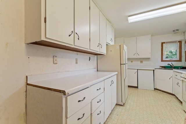 8309 39th St N, Lake Elmo, MN 55042 - kitchen featuring freestanding refrigerator, light countertops, white cabinets, a sink, and light floors