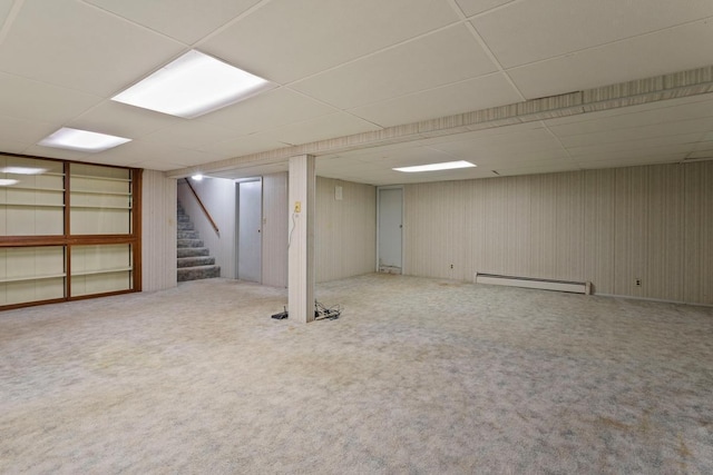 8309 39th St N, Lake Elmo, MN 55042 - finished below grade area featuring a baseboard radiator, a paneled ceiling, stairs, and carpet