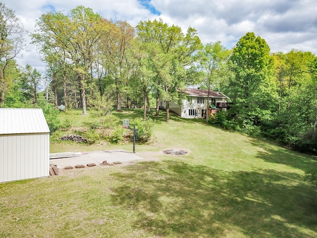 1941 230th St, Saint Croix Falls, WI 54024 - view of grassy yard featuring a fire pit, an outbuilding, and a wooden deck