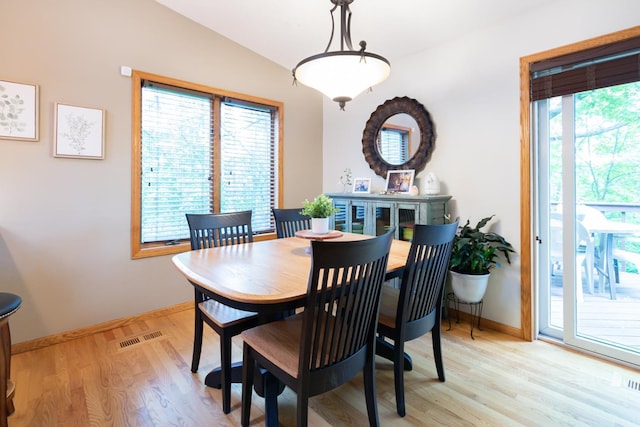 1941 230th St, Saint Croix Falls, WI 54024 - dining room with light wood-type flooring, lofted ceiling, and baseboards