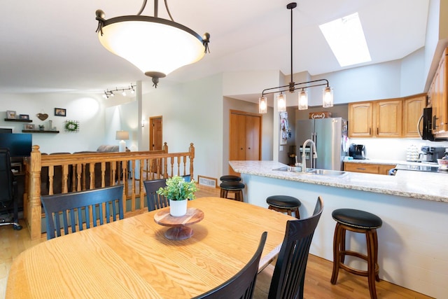 1941 230th St, Saint Croix Falls, WI 54024 - dining area featuring a skylight, light wood-style flooring, and track lighting